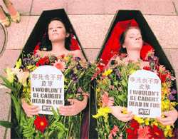 Members of the People for Ethical Treatment of Animals stage an anti-fur protest at the entrance of the Giorgio Armani fashion store in Taipei, Taiwan, on Monday.