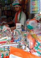 a shopkeeper busy selling national flag.