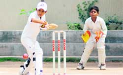 A batsman eyes the ball during a cricket match between GNPS and CCA Cricket Academy in Chandigarh 