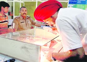 Forensic experts lift fingerprints at a shop, which was allegedly burgled, in Ludhiana