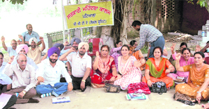 Members of the Government College Teachers Association stage a dharna at Government Mohindra College in Patiala on Tuesday.