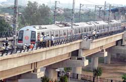 Rescue team checks a Metro train that derailed at Dwarka station in New Delhi