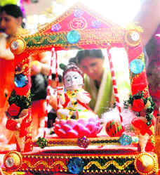 Devotees purchase an idol of Lord Krishna for Janmashtmi in Jammu on Wednesday. 