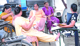 Power Woes: Unable to bear hot weather, the staff of Civil Hospital sit in the open  during a power cut in Jalandhar on Wednesday. 