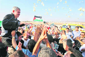 Palestinian Mohammed Mansour (50) is greeted by his relatives as he arrives at Jalameh checkpoint after his release from an Israeli prison on Tuesday. Mansour spent 25 years in prison for planting a bomb on a bus