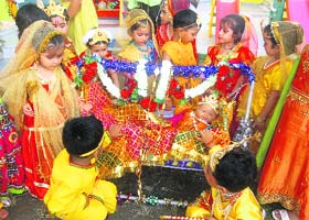 Children enact the birth of Lord Krishna as part of Janamashtmi celebrations in their school in Dehradun