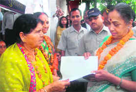 Sushila Dhyani, president of the Kaushaliya Sangarsh Vahini, presents a memorandum to Governor Margaret Alva in Dehradun on Thursday. 