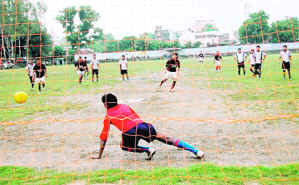 A goalkeeper dives to save a goal at the District Football League in Dehradun on Thursday.
