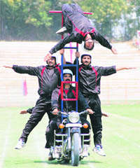 Police personnel display a daredevil act during the rehearsal in Srinagar.