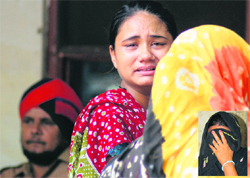 The daughter of the accused woman (inset) cries at the police station in Ludhiana on Thursday.