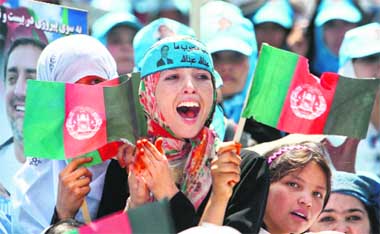 Women cheer for Afghan presidential candidate Abdullah Abdullah as he delivers a campaign speech outside Blue Mosque in Mazar-i-Sharif in Balkh province