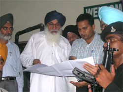 CM Parkash Singh Badal discussing details of a project with 