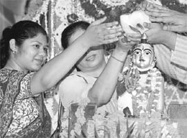 ISKCON devotees perform the kalash abhishek ceremony during Janmashtami at Hare Krishna Dham in Chandigarh on Friday.