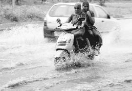 Young girls wade through a waterlogged road in Sector 42, Chandigarh, on Friday.