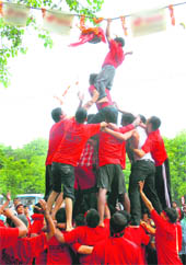 A devotee tries to break the matki on the occasion of Janmashtami in Chandigarh on Friday.