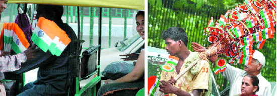 Vendors sell national flags on the eve of Independence Day in New Delhi on Friday. 