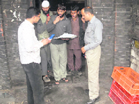 CID officers checking antecedents of Kashmiri labourers for security reasons on the eve of Independence Day at Shimla on Friday.