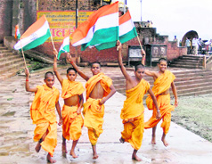 Batuks (students of Vedas) with the Tricolour on the bank of Ganga in Varanasi on Friday.