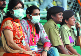  Women wear masks to protect themselves from swine flu during the Independence Day celebrations at Ambedkar Stadium in New Delhi on Saturday. 