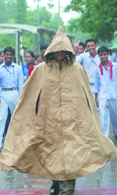 A security guard protects  himself from rain. 