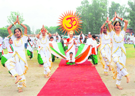 Schoolchildren present an item during the Independence Day function at Karna Stadium in Karnal on Saturday. 
