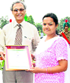 Dr Manjit Singh Kang honours Geetika Sheemar during the Independence Day function at PAU in Ludhiana on Saturday.