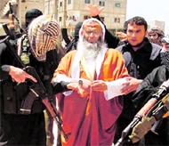 Abdel-Latif Moussa, the leader of an Islamist pan-Arab group (C), is surrounded by his bodyguards in Rafah in the southern Gaza Strip, on Friday.