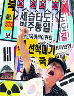 An anti-North Korea protester shouts a slogan during a rally in Seoul, on Saturday,
