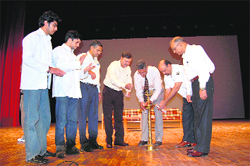 Dr Anil Chouhan, Principal, DRPGMC, lights the ceremonial lamp while inaugurating the CME programme in the Shoba Singh auditorium at Tanda on Sunday. 
