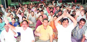 Members of the National Mazdoor Conference protest in support of their demands in Jammu