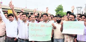 Members of the All-J&K Degree/Diploma Engineers Union protest in support of their pending demands at Exhibition Ground in Jammu