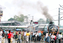 People brave rain at the inauguration of the Heritage Special Howrah-Bandel Train in Kolkata on Sunday.