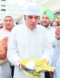 BJP MP from Pilibhit Varun Gandhi carries karah prasad at the Golden Temple in Amritsar on Sunday. He said the last time he visited Harmandar Sahib, along with his mother, was in his childhood and had participated in the kar sewa. Photo: Vishal Kumar