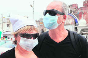 SWINE FLU SCARE: Foreign tourists with masks on the Golden Temple premises in Amritsar on Sunday.