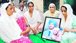 Family members of Balwinder Singh (inset) mourn his death at Gobind Nagar in Patiala
