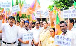 Leaders of the BJP stage a protest outside Congress Bhawan, Sector 35, Chandigarh,