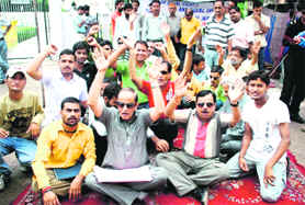 Members of the J&K Blind Association protest in support of their demands in front of the Divisional Commissioners office in Jammu on Monday. 