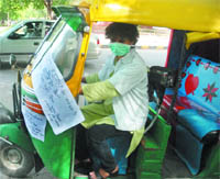 Autorickshaw driver Sunita gives free service during the auto strike in New Delhi on Tuesday. 