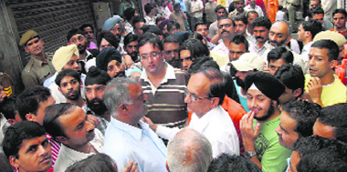 After the demolition of illegal structures in lower bazaar and the Mall road, market committee members talking to MC officers at Shimla on Tuesday.