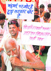 Activists of the BJP stage a dharna in protest against the rise in the prices of essential commodities in Karnal on Tuesday. 