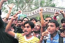 Students protest over the varsity issue outside MAM College in Jammu on Tuesday.
