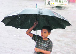 A child in a joyous mood after heavy rain in Ludhiana on Tuesday.