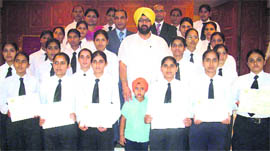Dreaming high: Girl students with their certificates in hospitality.