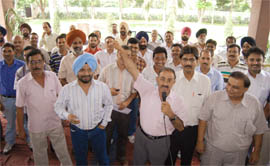 Members of the Income Tax Employees Union stage a dharna at Rishi Nagar in Ludhiana on Tuesday. 