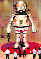Giant Torayan, a 7.2-metre tall aluminum-made robot, looms over visitors at Osaka city hall, Japan, on Tuesday. The mechanical sculpture, has been set at the lobby to promote Aqua Metropolis Osaka 2009, an upcoming event that stimulates people to reconsider a waterfront life style