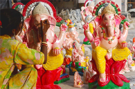 An artist giving finishing touches to an idol of Lord Ganesha ahead of Ganesh Chaturthi in Bathinda on Tuesday.