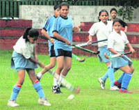A player advances towards the goalpost during a hockey match between Coaching Center-18 and Wanderers Club in Chandigarh on Wednesday.