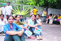 PU students stage a protest by closing gate No. 2 at girls hostel on Wednesday.
