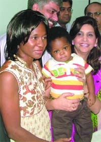 Eighteen-month-old Nigerian child Dike with his mother (L) and doctor Neelam Mohan after undergoing a successful liver transplant surgery at Ganga Ram Hospital in New Delhi
