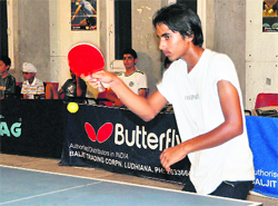 A boy plays a shot during a table tennis tournament in Ludhiana on Wednesday.